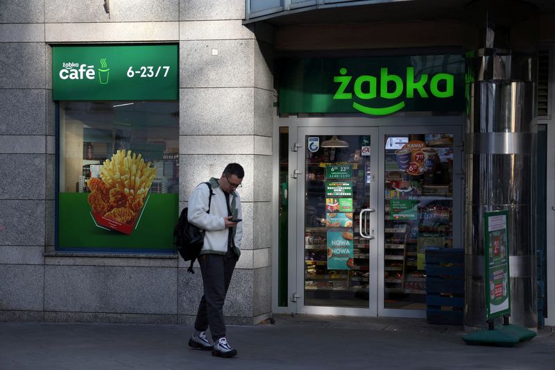 © Reuters. FILE PHOTO: A man stands in front of the Zabka's store in Warsaw, Poland, October 1, 2024. REUTERS/Kacper Pempel/File Photo