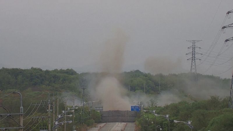 © Reuters. Smoke rises after North Korea blows up sections of inter-Korean roads on its side of the border between the two Koreas, according to South Korea's military, as seen from the South Korean side, October 15, 2024, in this screen grab from a handout video. South Korean Defence Ministry/Handout via REUTERS/File Photo