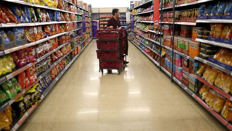 © Reuters. FILE PHOTO: An employee looks at the shelves inside a Sainsbury's supermarket in Cobham, Britain, October 2, 2024. REUTERS/Mina Kim/File Photo