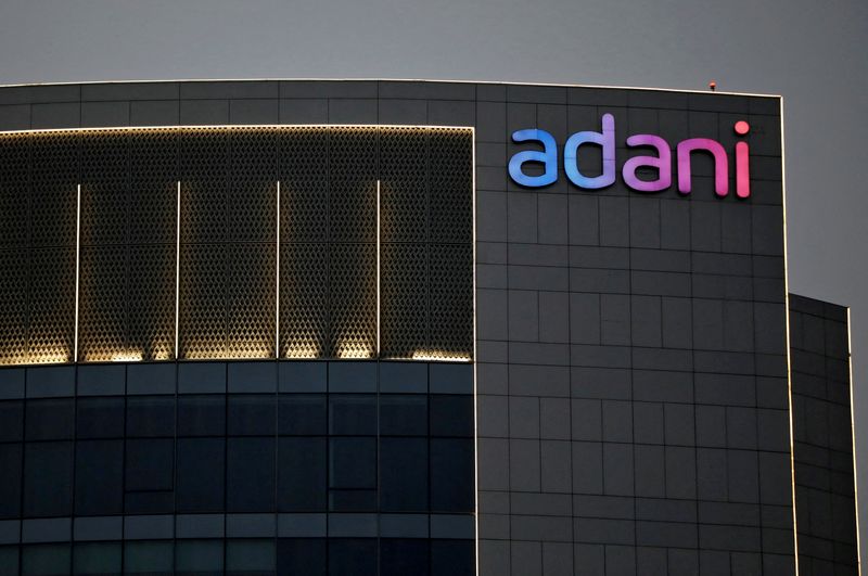 © Reuters. FILE PHOTO: The logo of the Adani Group is seen on the facade of one of its buildings on the outskirts of Ahmedabad, India, April 13, 2021. REUTERS/Amit Dave/File Photo/File Photo